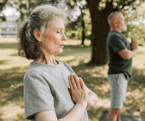 Person meditating peacefully in a calm, natural environment.